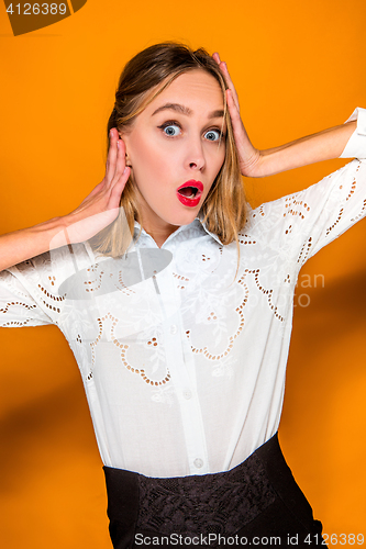 Image of Portrait of young woman with shocked facial expression