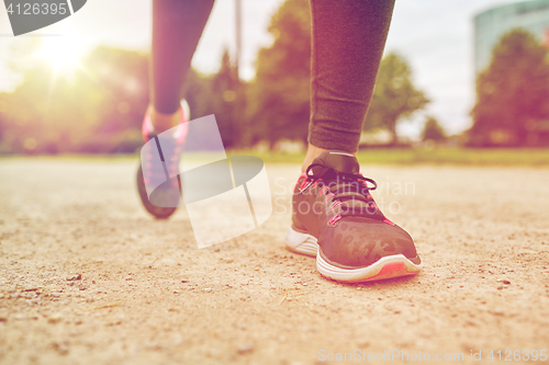 Image of close up of woman feet running on track from back