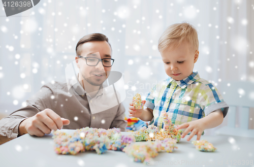 Image of father and son playing with ball clay at home