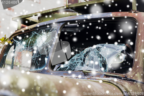 Image of war truck with broken windshield glass over snow