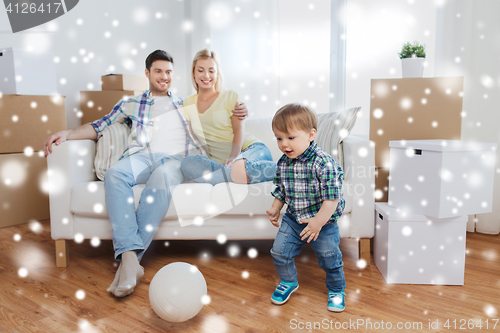 Image of happy family moving to new home and playing ball