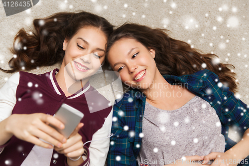 Image of teenage girls listening to music on smartphone