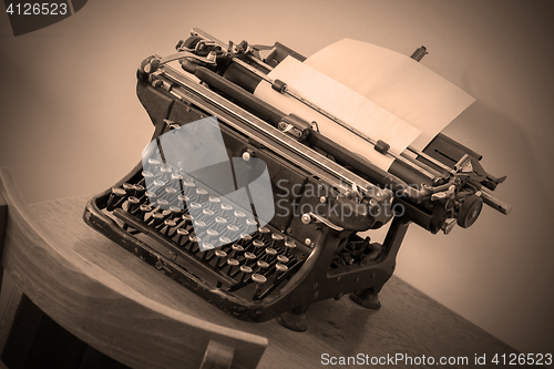 Image of Old typewriter on a small table