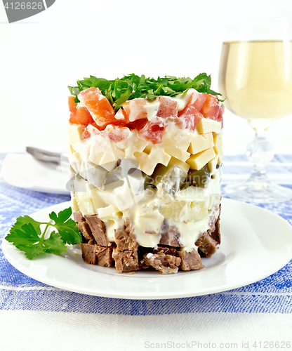 Image of Salad with beef and tomato on tablecloth