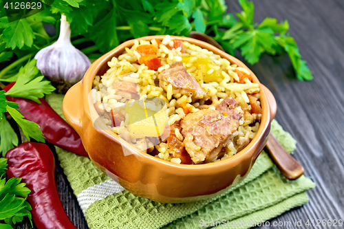 Image of Rice with chicken and zucchini in bowl on board