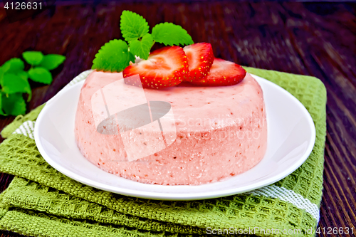 Image of Panna cotta strawberry on dark board