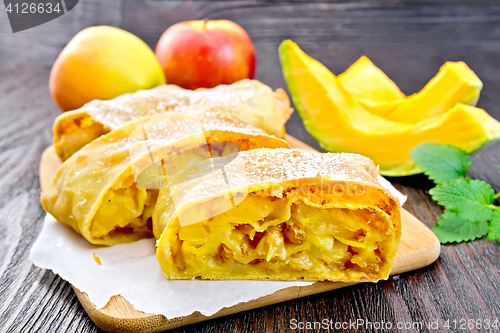 Image of Strudel pumpkin and apple on wooden board