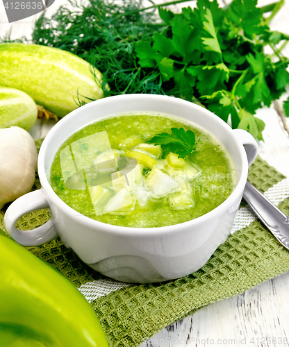 Image of Soup cucumber with garlic in white bowl on board