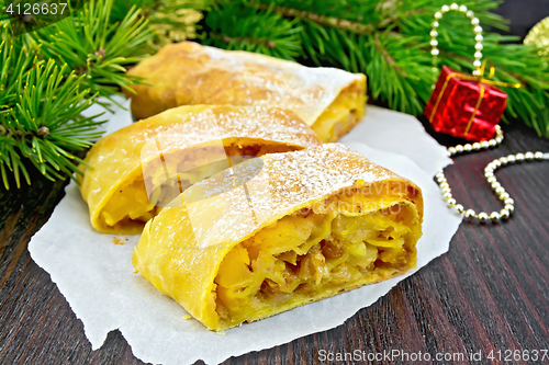 Image of Strudel pumpkin and apple with Christmas toys on board