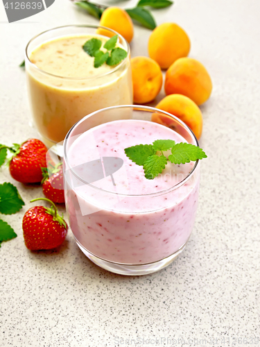 Image of Milkshake strawberry and apricot on granite table