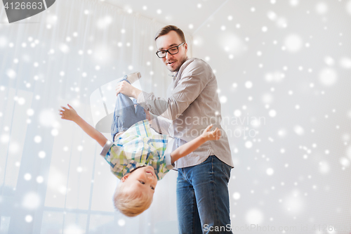 Image of father with son playing and having fun at home