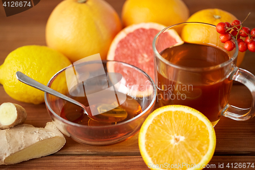 Image of tea with honey, lemon and ginger on wood