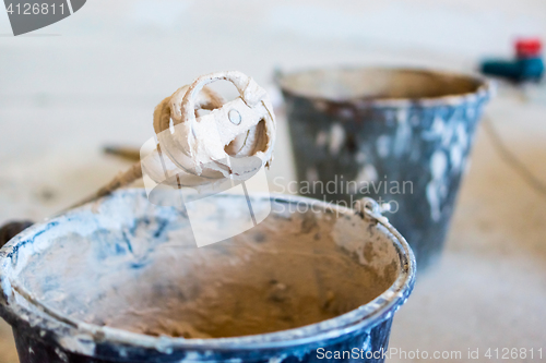 Image of Construction theme - buckets of cement mixture