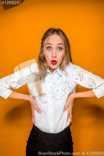 Image of Portrait of young woman with shocked facial expression