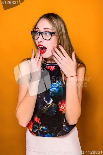 Image of Portrait of young woman with shocked facial expression