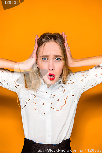 Image of Portrait of young woman with shocked facial expression