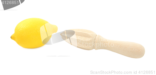 Image of Whole lemon and wooden citrus reamer