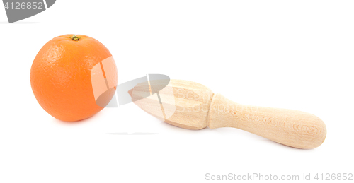 Image of Whole orange and wooden citrus reamer