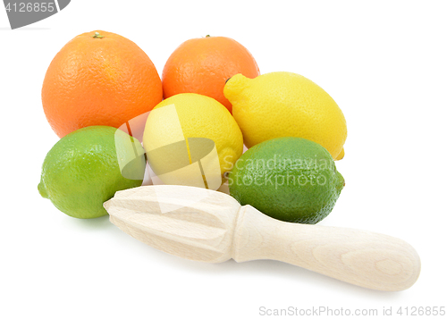 Image of Six citrus fruits with a wooden reamer