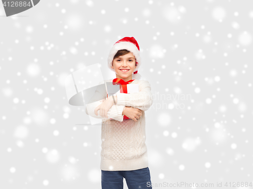 Image of smiling happy boy in santa hat with gift box