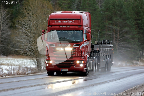 Image of Red Scania R560 Truck High Beams on Winter Road