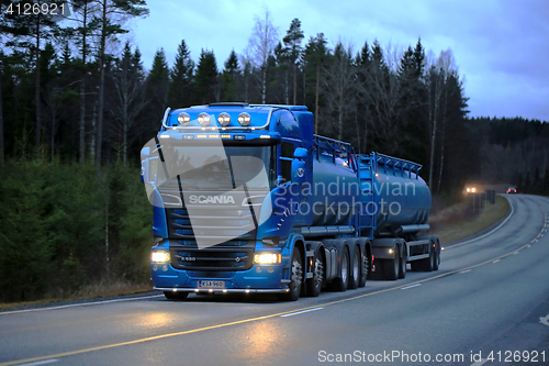 Image of Blue Scania R580 on Dark Rural Road