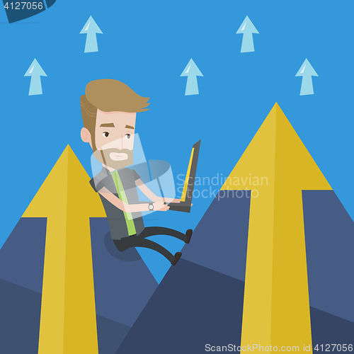 Image of Businessman working on laptop in the mountains.