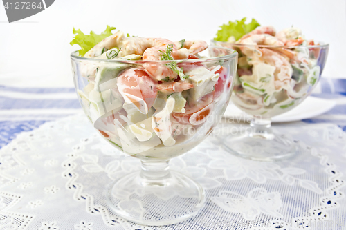 Image of Salad with shrimp and avocado in glass on white napkin