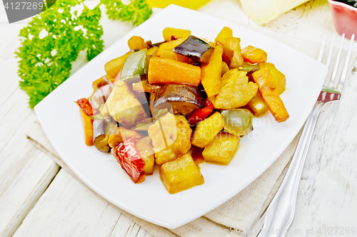 Image of Roast with vegetables and honey in plate on light board