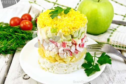 Image of Salad of crab sticks and apple on light board