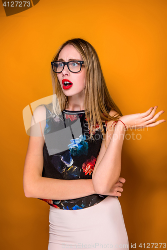 Image of Portrait of young woman with shocked facial expression