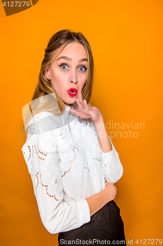 Image of Portrait of young woman with shocked facial expression