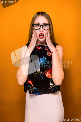 Image of Portrait of young woman with shocked facial expression