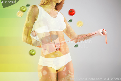 Image of Woman holding meter measuring perfect shape of her beautiful body