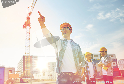 Image of builders pointing finger aside on construction