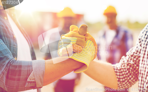 Image of close up of builders hands making handshake