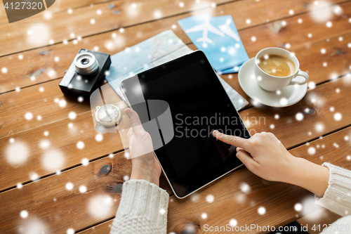 Image of close up of traveler hands with tablet pc and map