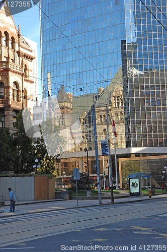 Image of Reflection of old city hall in high rise.