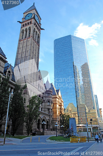 Image of Old city hall tower and high-rise.