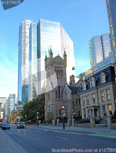 Image of High rise with old church.