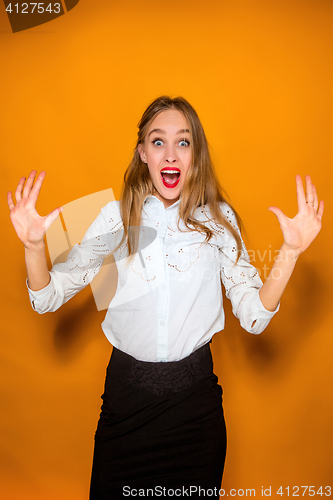 Image of Portrait of young woman with shocked facial expression