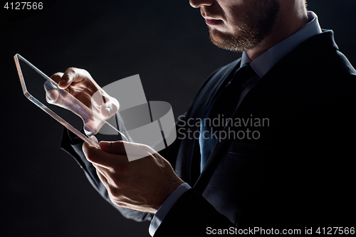 Image of close up of businessman with transparent tablet pc