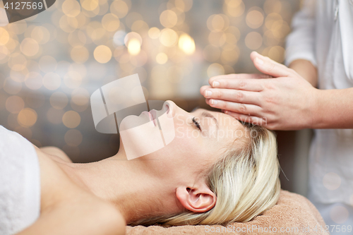 Image of close up of woman having face massage in spa