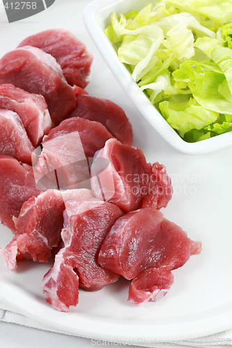 Image of Raw pork meat with iceberg lettuce