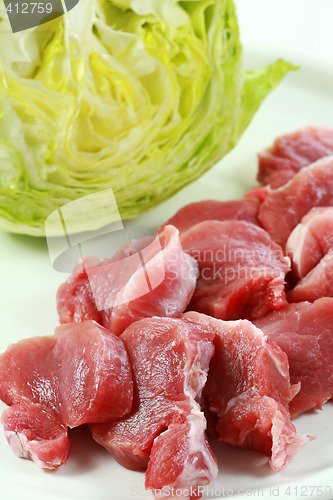 Image of Raw pork meat with iceberg lettuce