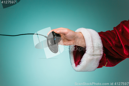 Image of Hand of Santa Claus pressing on the remote gaming consoles