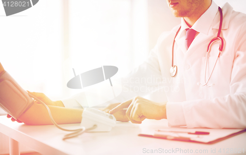 Image of doctor and patient measuring blood pressure