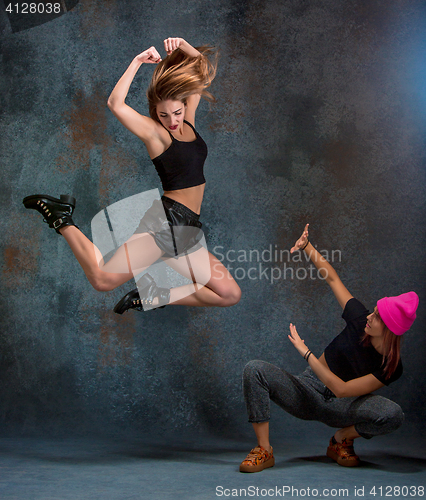 Image of The two attractive girls dancing twerk in the studio