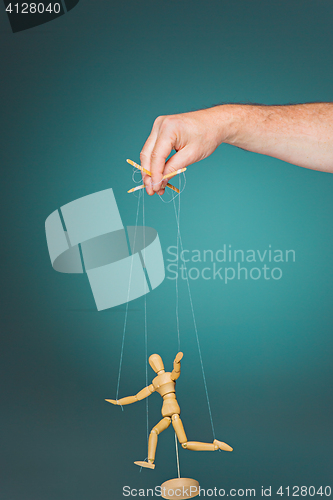 Image of Image puppet in the hands of the puppeteer