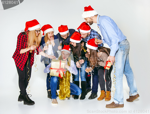 Image of Many young women and men drinking at christmas party